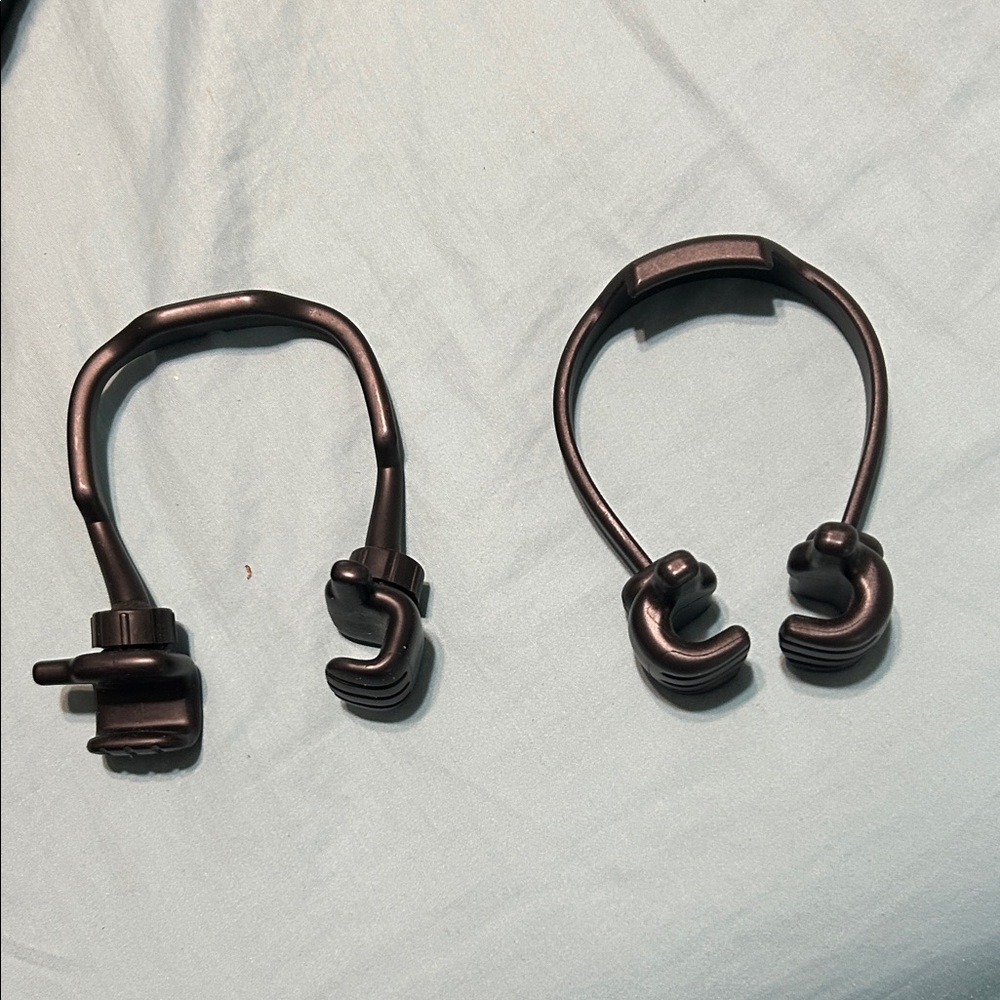 Black phone holders. One can move hands. Other cannot. New - Picture 2 of 4